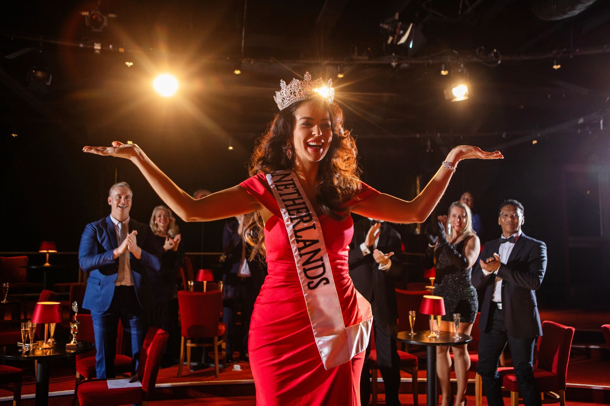 Confident women on stage with crown and sash